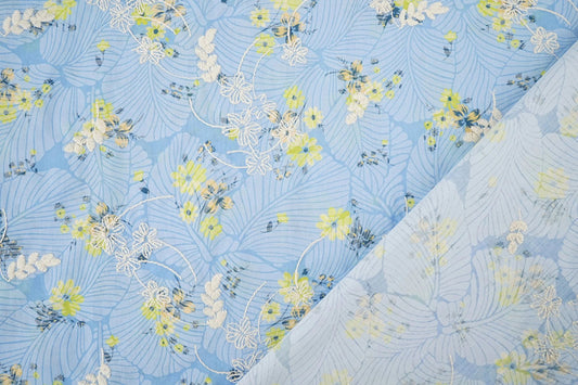 Image of embroidered cotton fabric - yellow flowers on blue 115 g/m² – available at Šarlotes audumi