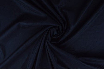 Image avec doublure en maille extensible - bleu foncé 75 g/m² – disponible chez Tissus Charlotte
