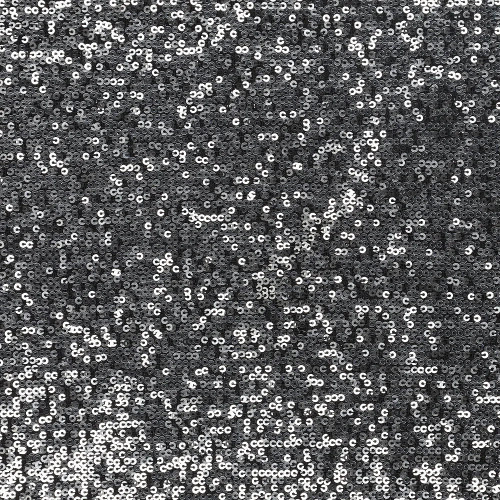 Image d’un tissu à sequins noir et argent 285 g/m² – disponible chez Šarlotes audumi
