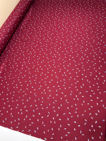 Image of burgundy Italian twill fabric with a subtle pattern – available online at Šarlotes audumi
