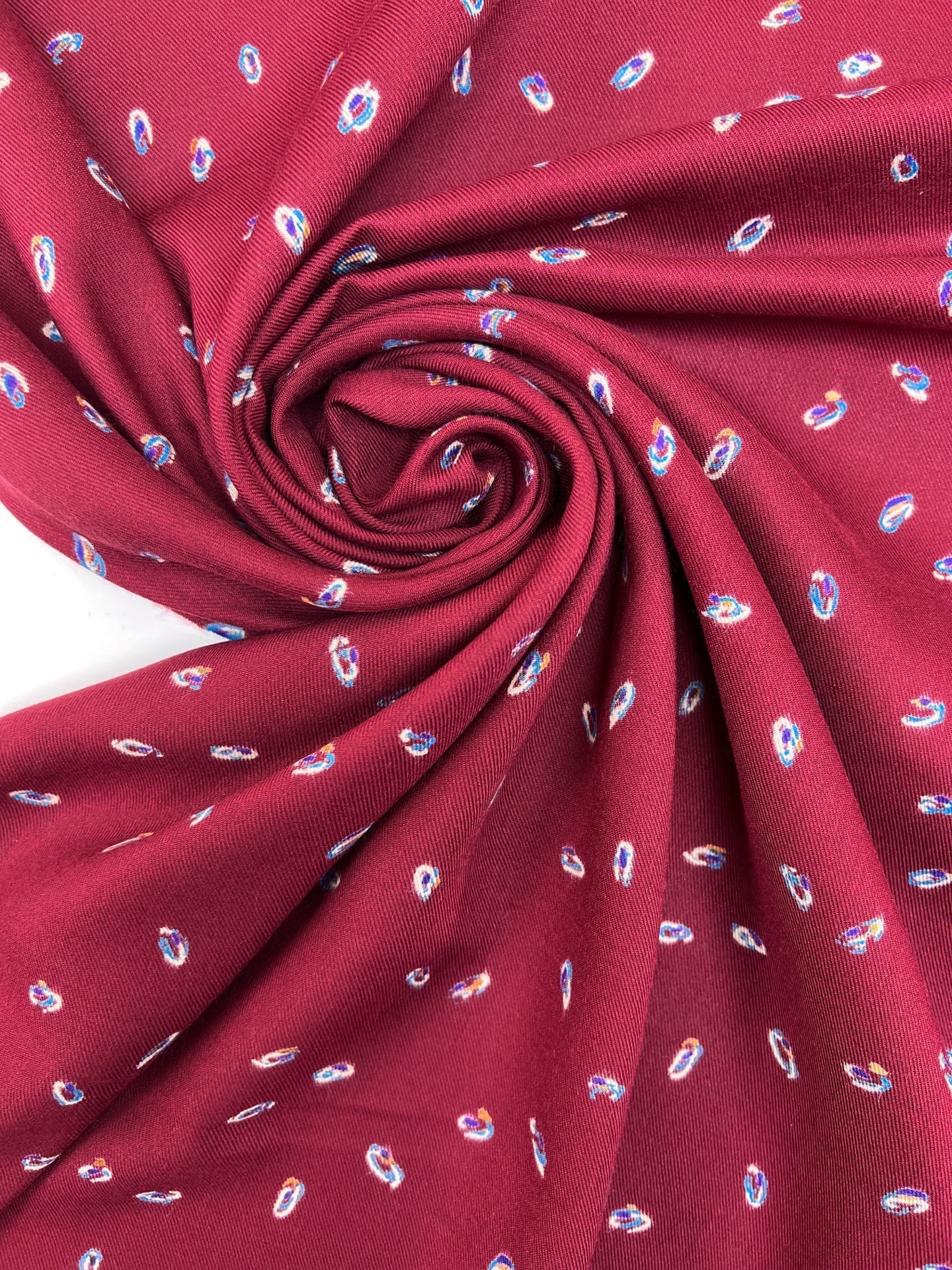 Image of Italian twill fabric in burgundy with a subtle pattern – available online at Šarlotes audumi