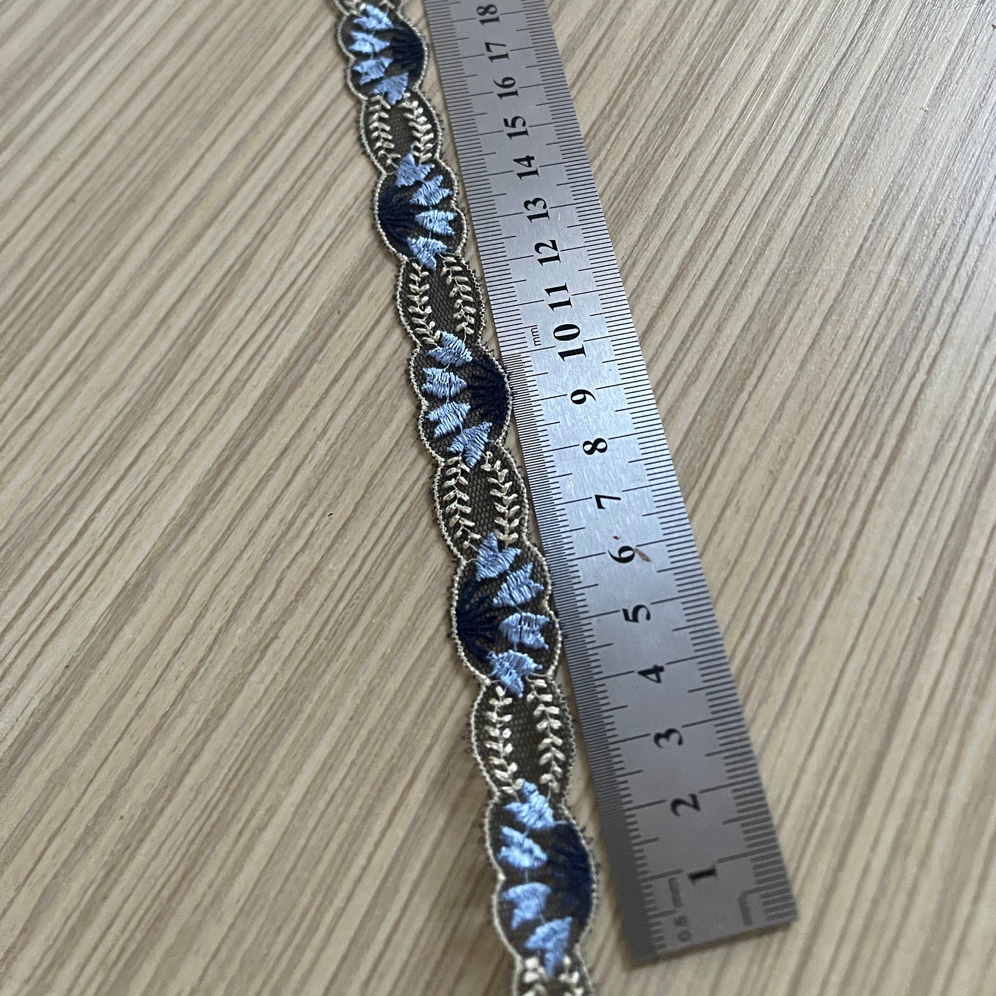 Image of embroidered lace ribbon 2 cm - dark blue with beige accents – available at Šarlotes audumi
