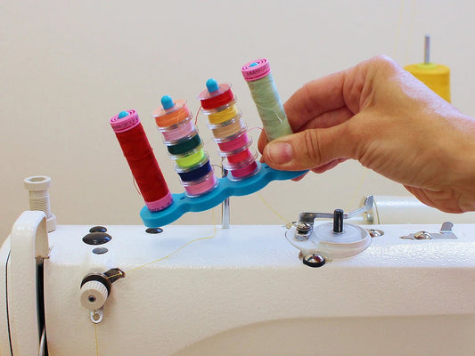 Image of a magnetic bobbin holder for sewing machines – available at Charlotte's Fabrics