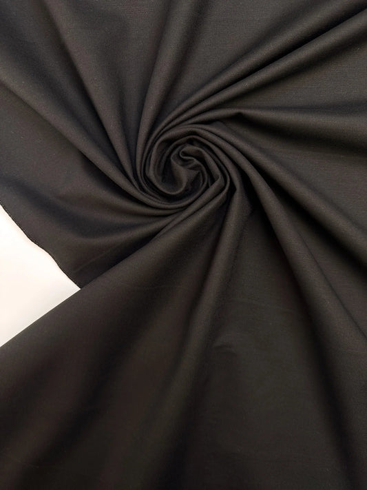 Image with black cotton suit fabric with elastane and moiré effect – Italy – available online at Šarlotes audumi