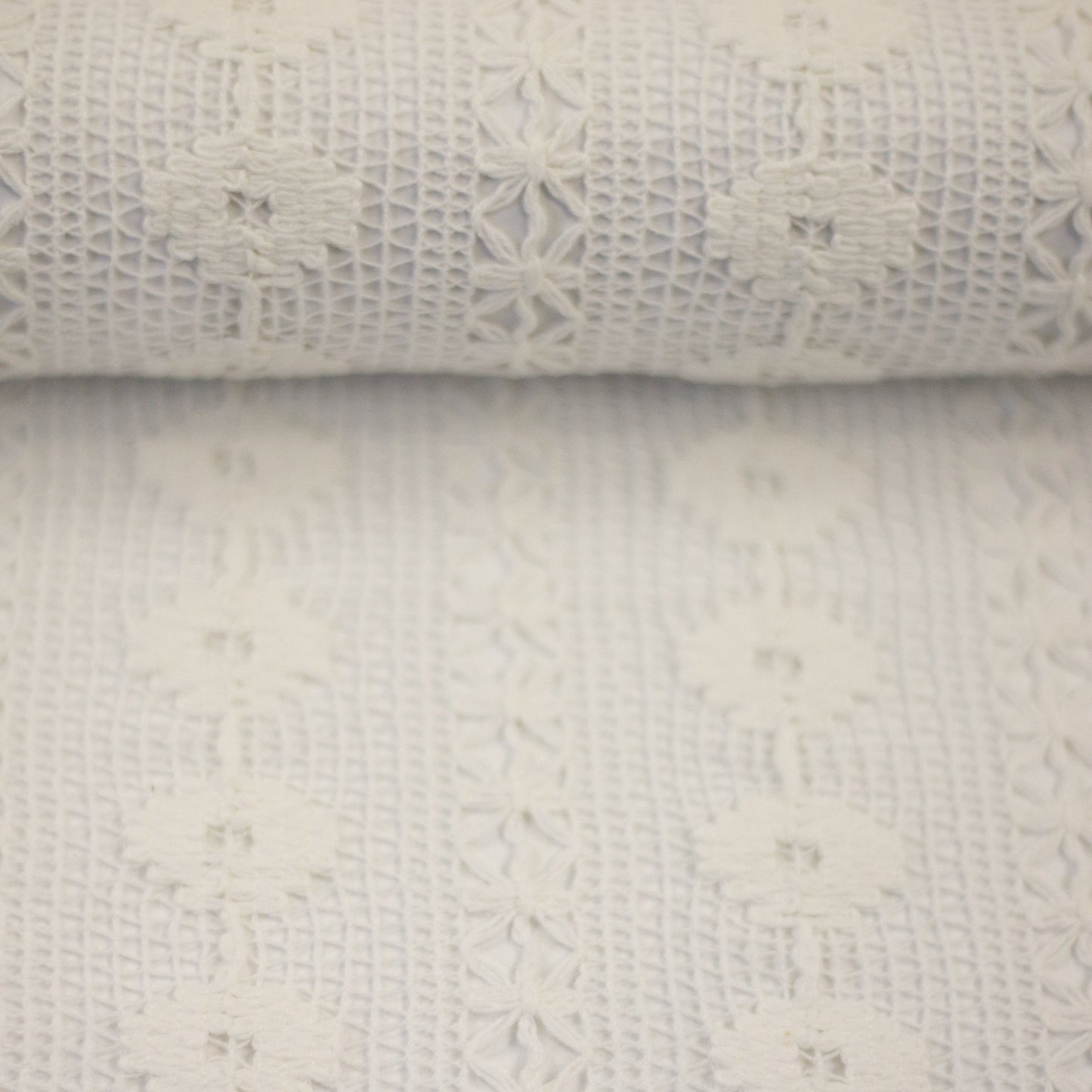 Image of lace fabric, warm white with a floral pattern – available online at Charlotte's Fabrics