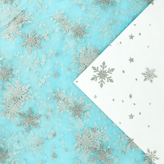 Image of soft tulle with silver snowflakes - aqua shade 30 g/m² – available at Charlotte's Fabrics