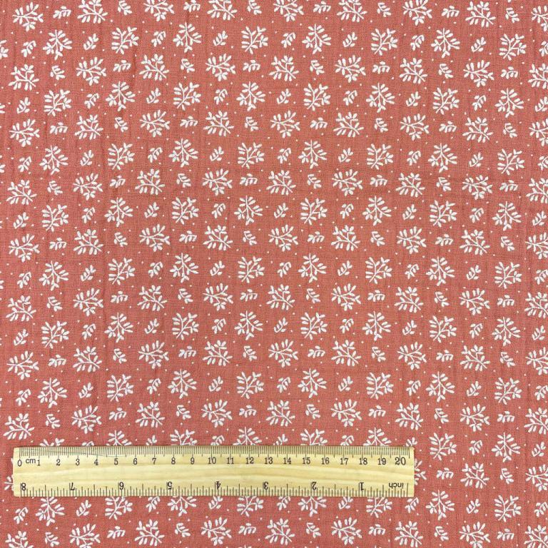 Mousseline - fleurs blanches sur fond orange 130 g/m²