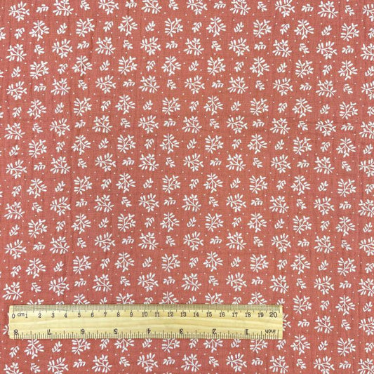 Mousseline - fleurs blanches sur fond orange 130 g/m²