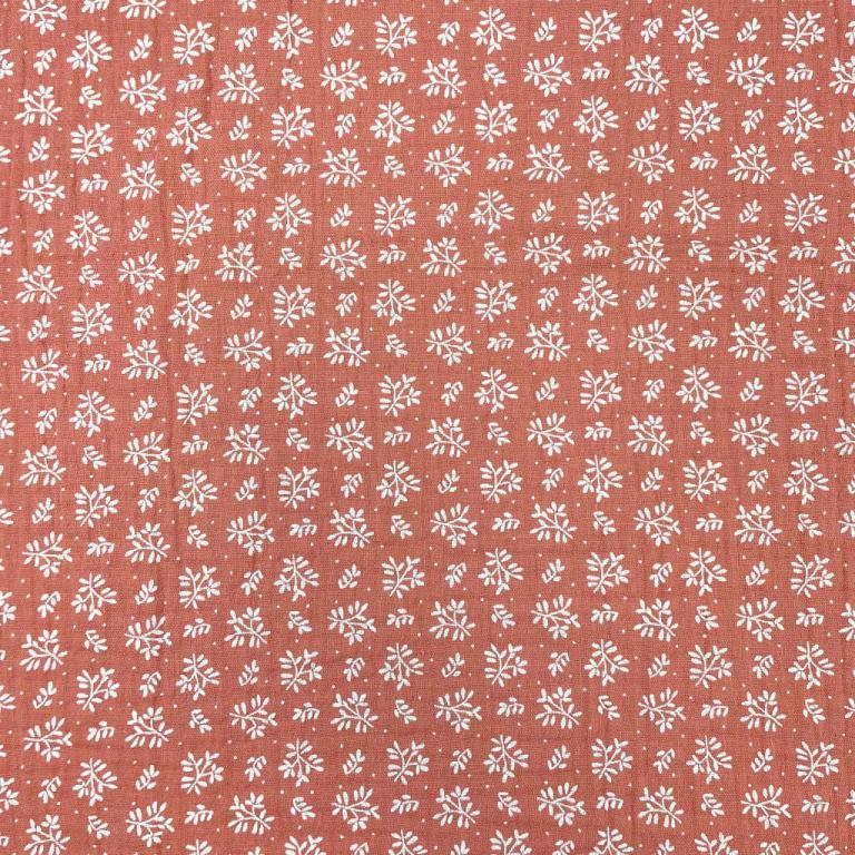 Mousseline - fleurs blanches sur fond orange 130 g/m²
