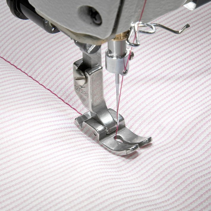 Image of an industrial sewing machine presser foot for straight stitch on thick fabrics – available at Charlotte Fabrics