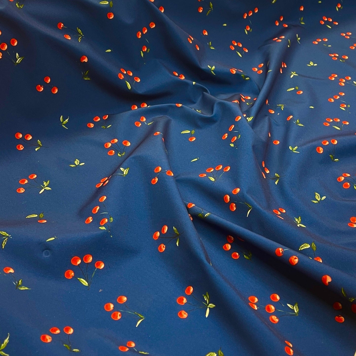 Image with Softshell fabric - cherries on dark blue 300 g/m² – available at Šarlotes audumi