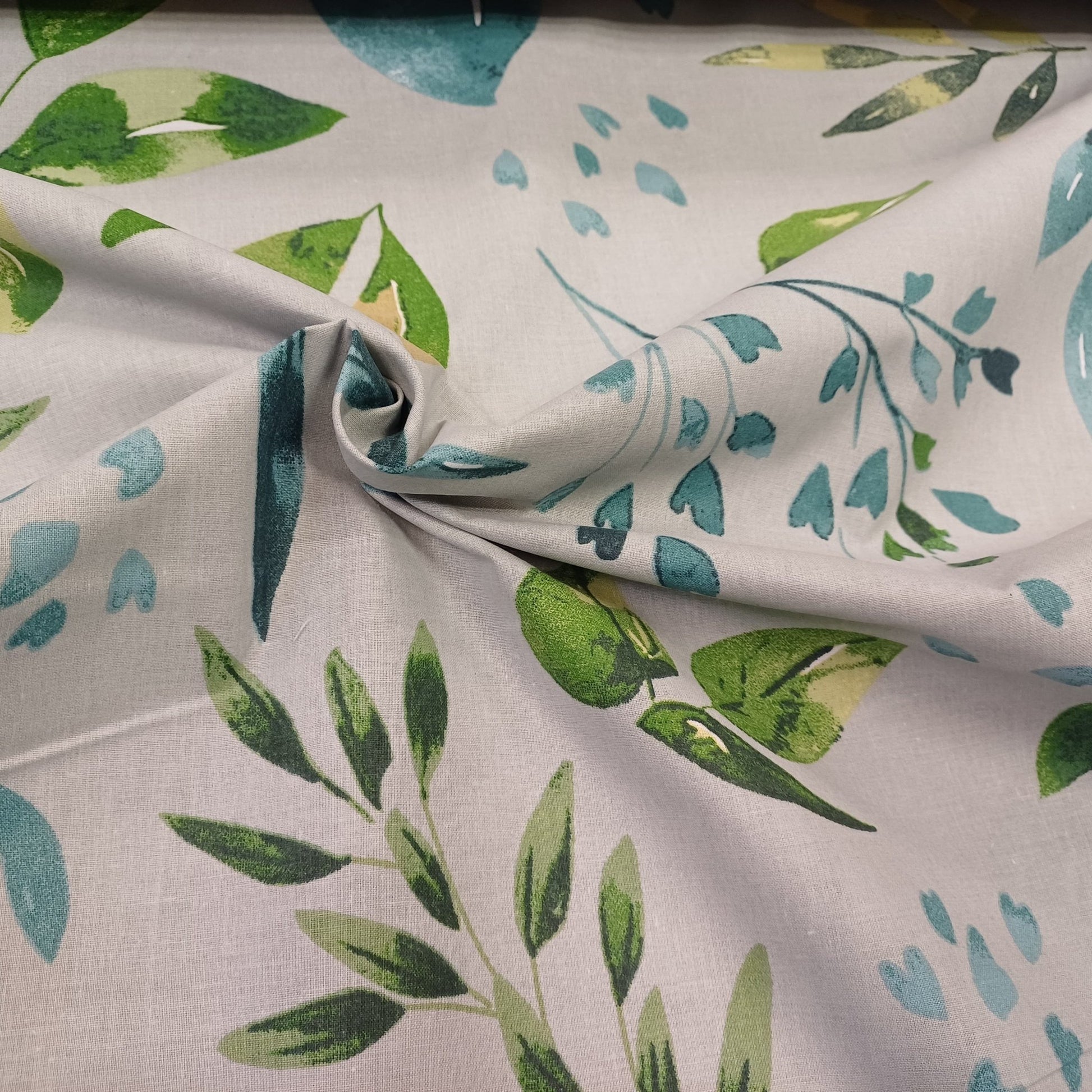 Tissu 100 % coton - feuilles vertes et bleu pétrole sur fond gris 130 g/m²